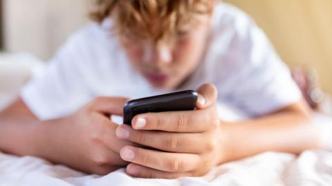 A child using a mobile phone
