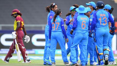 India cricketers celebrate a wicket against West Indies