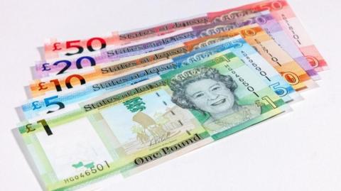A picture of Jersey currency in various colours against a white background 