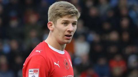 James Connolly in action for Crewe Alexandra. He is wearing a red home shirt