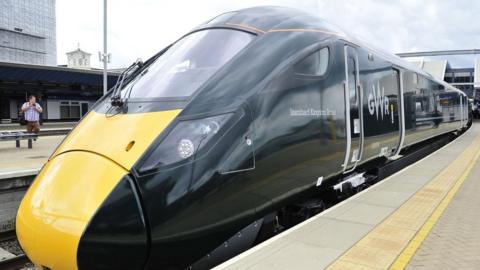 A GWR train waiting at a station platform