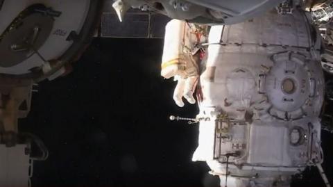 Cosmonaut conducts spacewalk outside the ISS. 11 Dec 2018