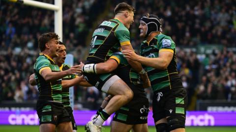 Northampton players celebrate a try