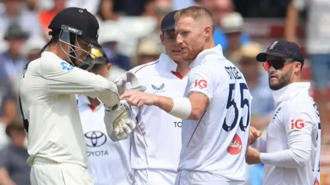 England captain Ben Stokes points to Mitchell Santner's glove after the New Zealand batter reviews being given out