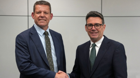 A formal picture of Rhun ap Iorwerth and Andy Burnham shaking hands