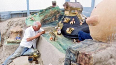 Sand sculptor Fred Darrington working in Weymouth.