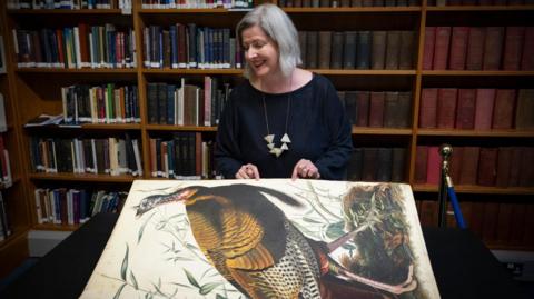  Claire McDade turning the page of the book