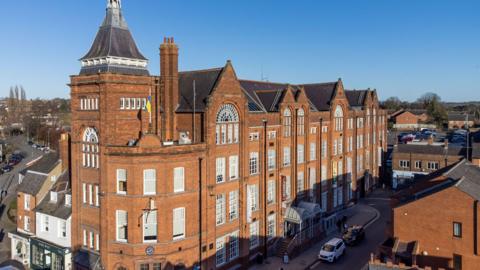 A red-brick Victorian-style large former factory.