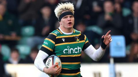Henry Pollock celebrates on his way to scoring a try for Northampton