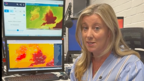 Sara Thornton in front of a weather map