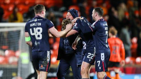 Dundee celebrate their derby victory at Tannadice