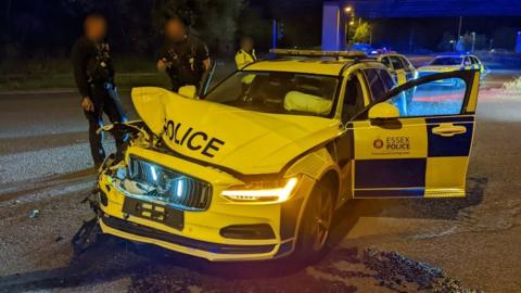 Police officers and damaged police car