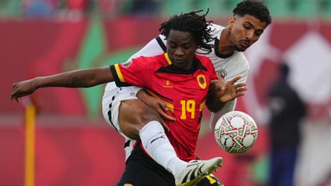 Angola's Mabululu battles for the ball with an Egypt defender