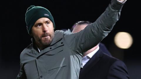 Ryan Reynolds waves to the Wrexham fans