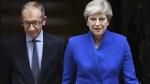 Theresa May heads out of Downing Street on her way to see the Queen