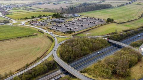 An artist's impression of the Barnetby Top lorry park with the junction of the A15 and M180 captured.