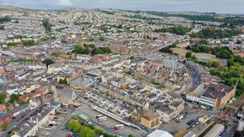 An aerial view of Paignton's town centre, with shops, roads and buses in view.