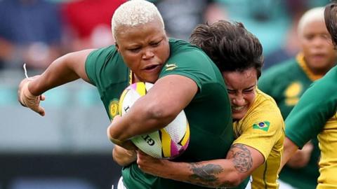 Aseza Hele carries the ball