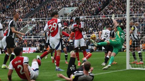 Premier League game between Newcastle and Arsenal shows a goal mouth scramble