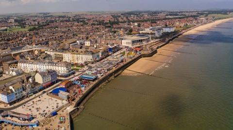 Aerial view of Bridlington showing the sea in the foreground and houses and other buildings