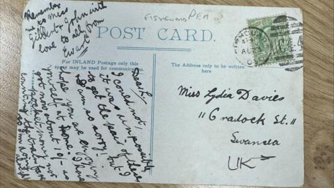 A picture of the postcard with writing on the back