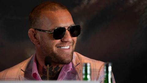 Conor McGregor in sunglasses smiling