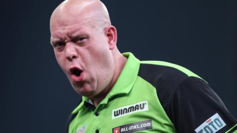 Michael Van Gerwen reacts to a dart narrowly finding the target