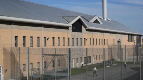 Prison guards walk through HMP Berwyn on March 15, 2017 in Wrexham, Wales. The mainly category C prison is one of the biggest jails in Europe capable of housing around to 2,100 inmates. 