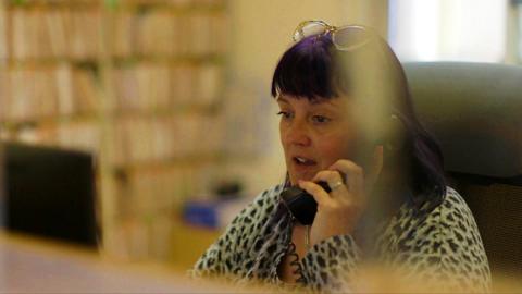 A receptionist answers the phone