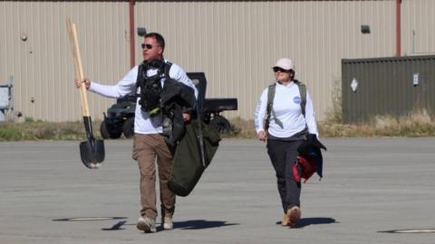 Rescue workers arrive back at the military base