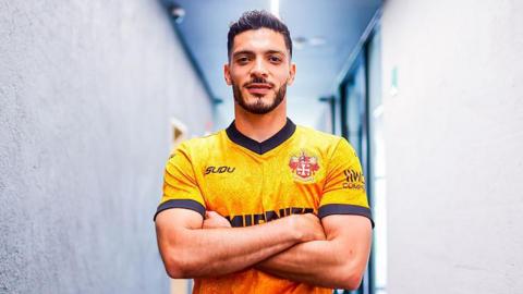 Raul Jimenez poses after re-signing for Wolves