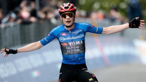 Jonas Vingegaard spreads his arms out as he celebrates winning stage nine of the Giro d'Italia