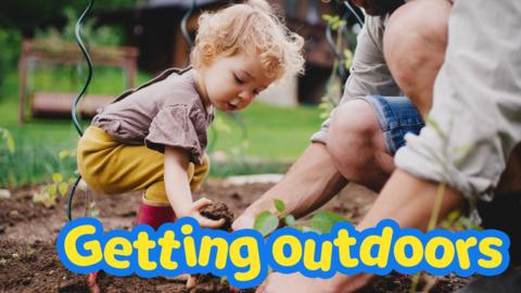 Father and child playing together in garden.