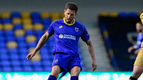 Sam Hutchinson in action for AFC Wimbledon 