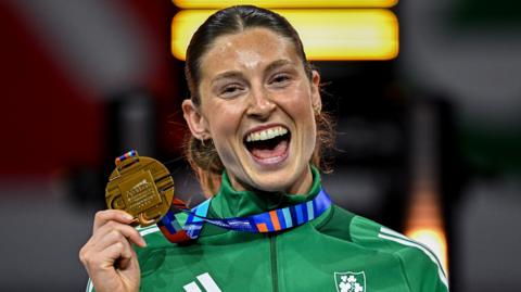 Kate O'Connor celebrates with her bronze medal