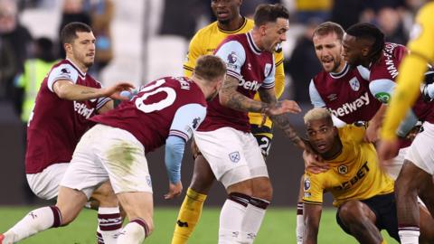 Mario Lemina and Jarrod Bowen clashing and surrounded by teammates 