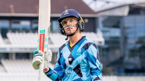 Lauren Winfield-Hill raises her bat to the crowd after scoring 98 for Northern Diamonds against Western Storm