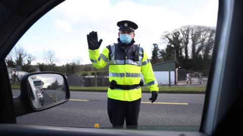 Garda stop vehicles at a checkpoint on the Irish border between Emyvale and Aughnacloy on 8 February 2021