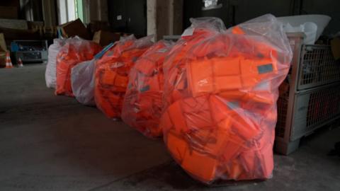 Thousands of life jackets, covered in plastic wrapping, were seized by the German authorities in the spring