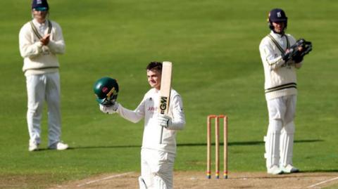 Freddie McCann receives applause from Warwickshire wicketkeeper Michael Burgess after reaching his second century in five first-class games