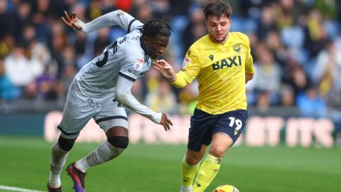 Romain Esse of Millwall and Tyler Goodrham of Oxford United in action