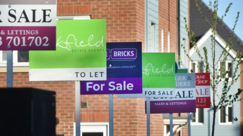 For sale signs outside some houses