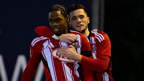 Exeter City players celebrate a goal