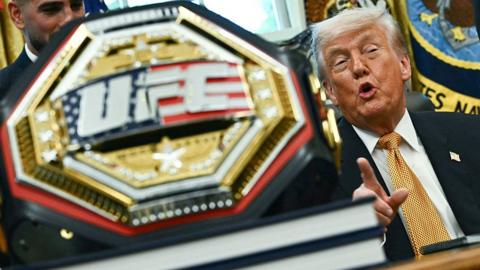 Donald Trump next to a UFC belt