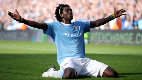 Emmanuel Adebayor celebrates a goal for Manchester City by kneeling down and stretching his arms out wide