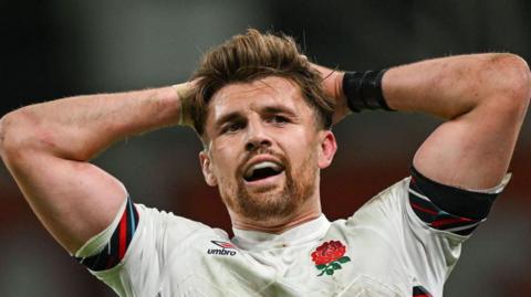 Henry Slade with his hands on his head