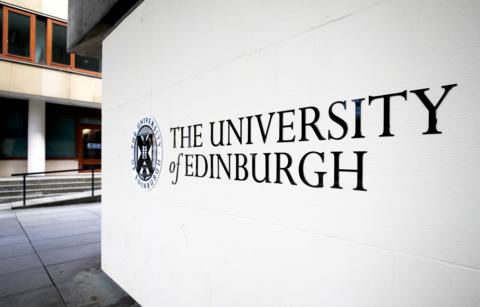 A brick wall painted white with a University of Edinburgh sign