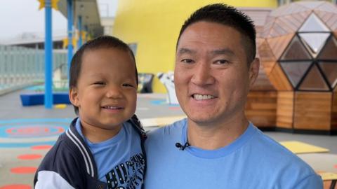 Oliver Chu and his Dad smile at the camera