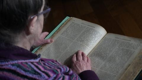 Mòrag Rothach a' leughadh an leabhair