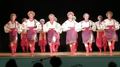 A troupe of female dancers in traditional Ukrainian headdress and outfits